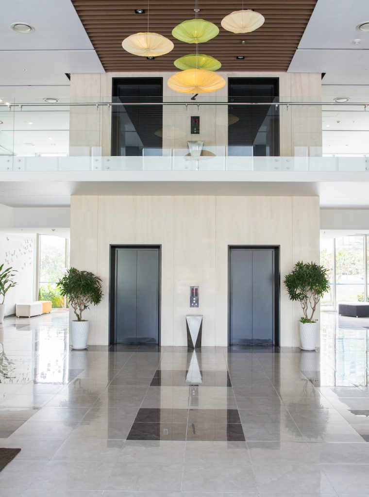 Empty lobby of condominium building. Elevators in hall of modern business center. Stylish interior design concept